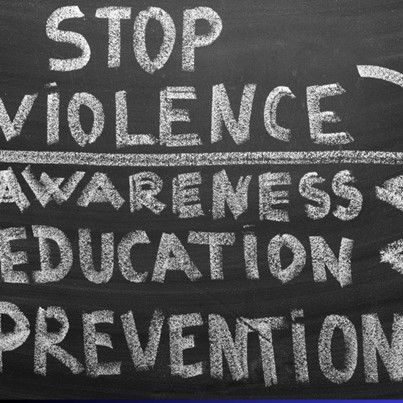 text "stop vioolence awareness education and prevention" written on blackboard
